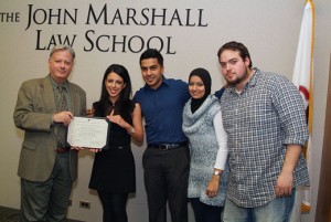Associate Dean William Powers presented the Middle Eastern Law Students Association (MELSA) a merit award for distinguished service at the evening division Holiday Party. Marvet Sweis (second from left), president of MELSA, is joined by (from third from left) Jimmy Samad; Farhana Hafezi and Tarek Khalil.