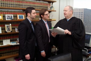 Circuit Court of Cook County Judge James P. Flannery stressed one of the finer points of a case when he met with Alex Turner (left) and Scott Duxbury (center) during their spring 2011 semester externship.