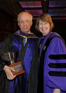 Professor Walter J. Kendall III is congratulated by Associate Dean Kathryn Kennedy upon receiving the Dedicated Service Award.