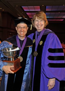 Professor Jason Kilborn is delighted to be receiving the Scholarly Achievement Award at commencement. The award was presented by Associate Dean Kathryn Kennedy.