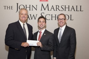Anthony Gattuso (center) accepts his $5,000 Elmer C. Kissane Public Service Award from Paul Kissane (left), son of Elmer C. Kissane in whose memory the award was established. Offering congratulations is Associate Dean Anthony Niedwiecki (right).
