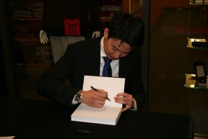 Professor Daryl Lim signs a copy of his book Patent Misuse and Antitrust Law: Empirical, Doctrinal and Policy Perspectives at a February book signing. Lim teaches intellectual property and antitrust law.
