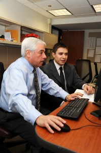 Michael Schlesinger (left), director of the Business Enterprise Law Clinic, works with student Jason Leigh on a project.