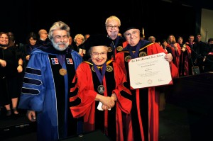 Leonard Amari (right), president of the John Marshall Board of Trustees, presents Harriet Hausman with an honorary degree at the May commencement. They are joined by Associate Dean Ralph Ruebner (left) and Dean John E. Corkery.